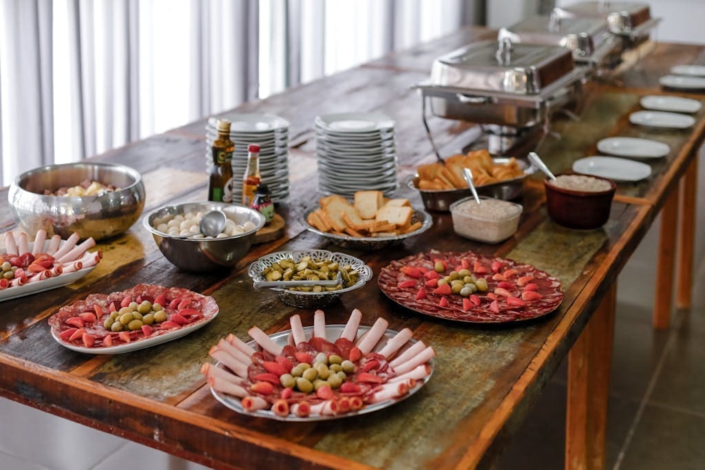A sophisticated buffet spread featuring various meats, cheeses, and appetizers indoors.